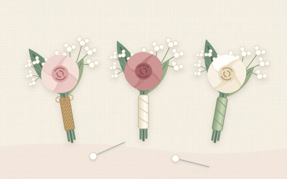 Three finished boutonnieres on a linen cloth, each a small rose with a leaf and filler, beside two pearl-headed pins