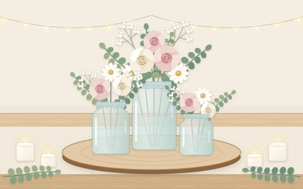 A long table with a linen runner and three glass jars of different heights filled with blush and white flowers on a round wooden slice