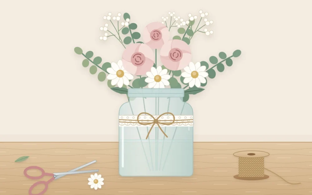 A glass jar wrapped with a lace band and a twine bow, holding blush roses, white daisies and eucalyptus on a wooden table