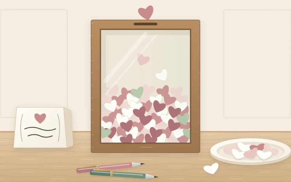 A glass shadow box frame half filled with small paper hearts on a table, with a shallow dish of blank paper hearts and two pens beside it
